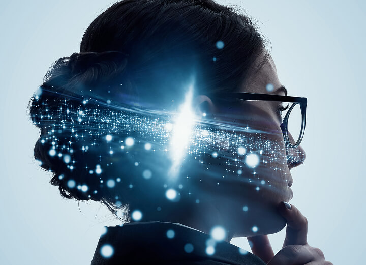Woman with glasses thinking with her hand on her chin with light particles.