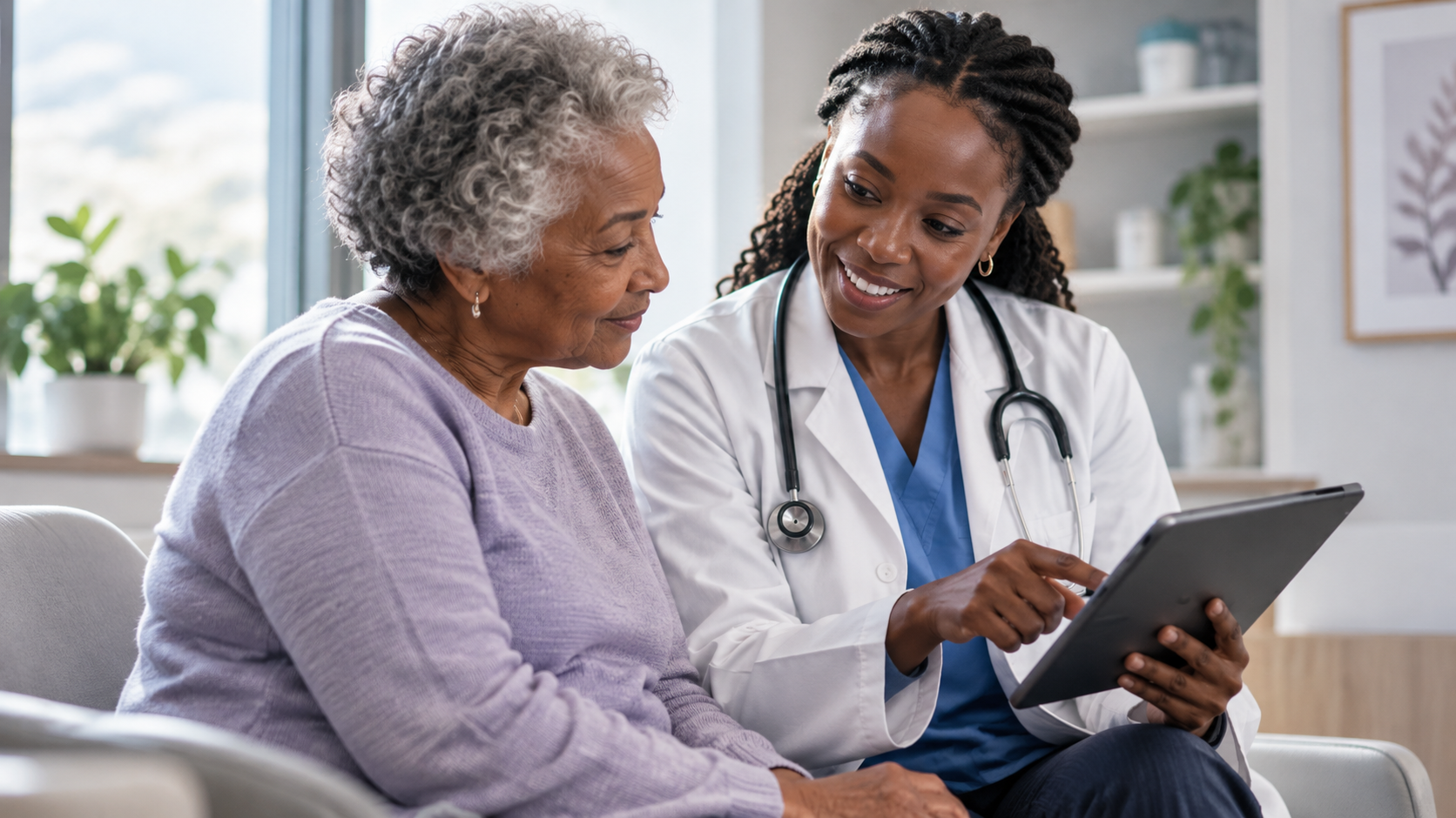 reviewing information on a tablet with an older female patient in a medical office.