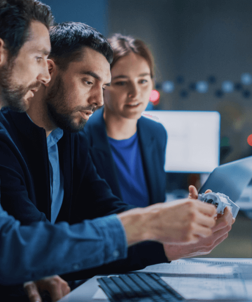 Two male and one female working professional discussing mechanical prototype