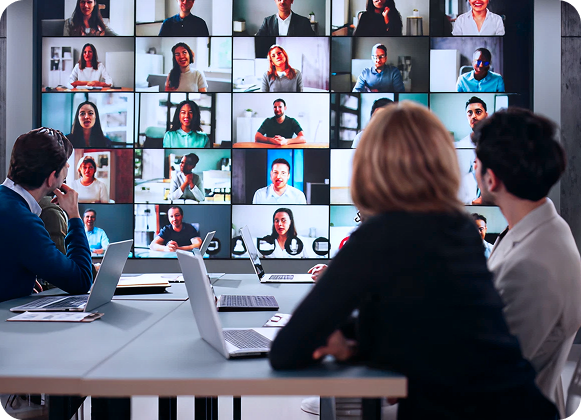 Hybrid team collaborating in person and online, representing RevStar’s digital transformation process.