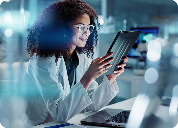 Healthcare researcher using a tablet in a lab, representing the healthcare sector among the industries we serve.