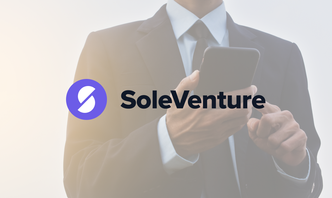 entreprenuer in a suit and tie using a phone